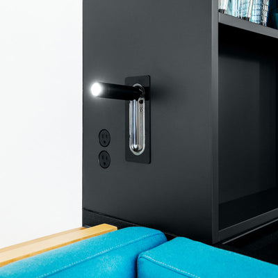A Bocci black cabinet with a light on it.