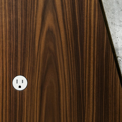 A close up of a wooden surface with a Bocci 22: Alternate Material Mounting white button.