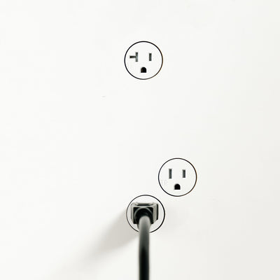 A black and white photo of three Bocci 22: Drywall Mud-In Mounting electrical outlets.