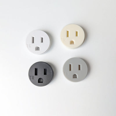 Three different types of Bocci 22 Finish Sample electrical plugs on a white surface.