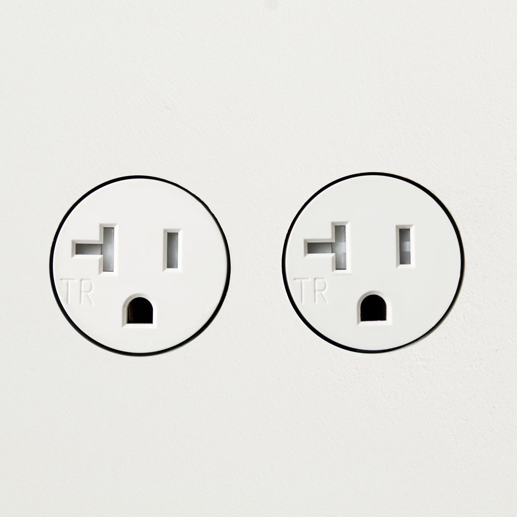 A couple of Bocci 22: Drywall Mud-In Mounting plugs sitting next to each other.