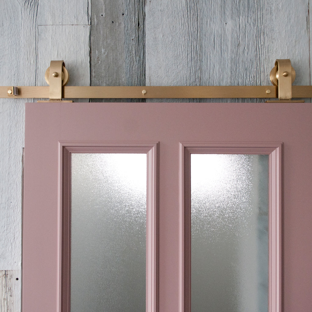 Pink Door with Brass barn door hardware