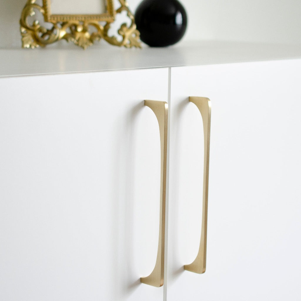 A white cabinet with a Baccman Berglund Bridge Pull handle on it.