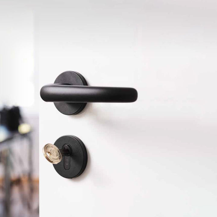 A CES Key Cylinder 815 Knob ET handle on a white door.