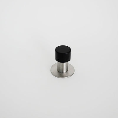 An AHI Capped Door Stop with a black and silver knob on a white surface.
