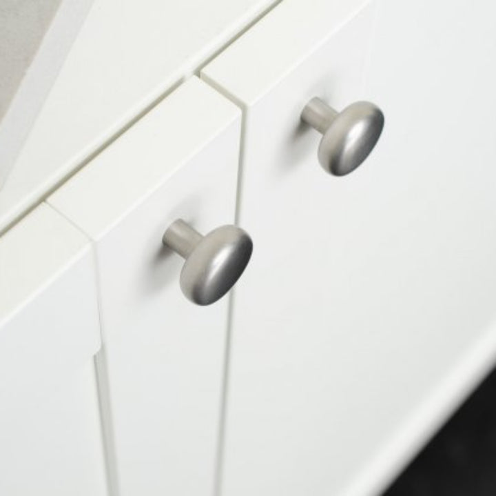Close-up of white kitchen cabinets with silver knobs