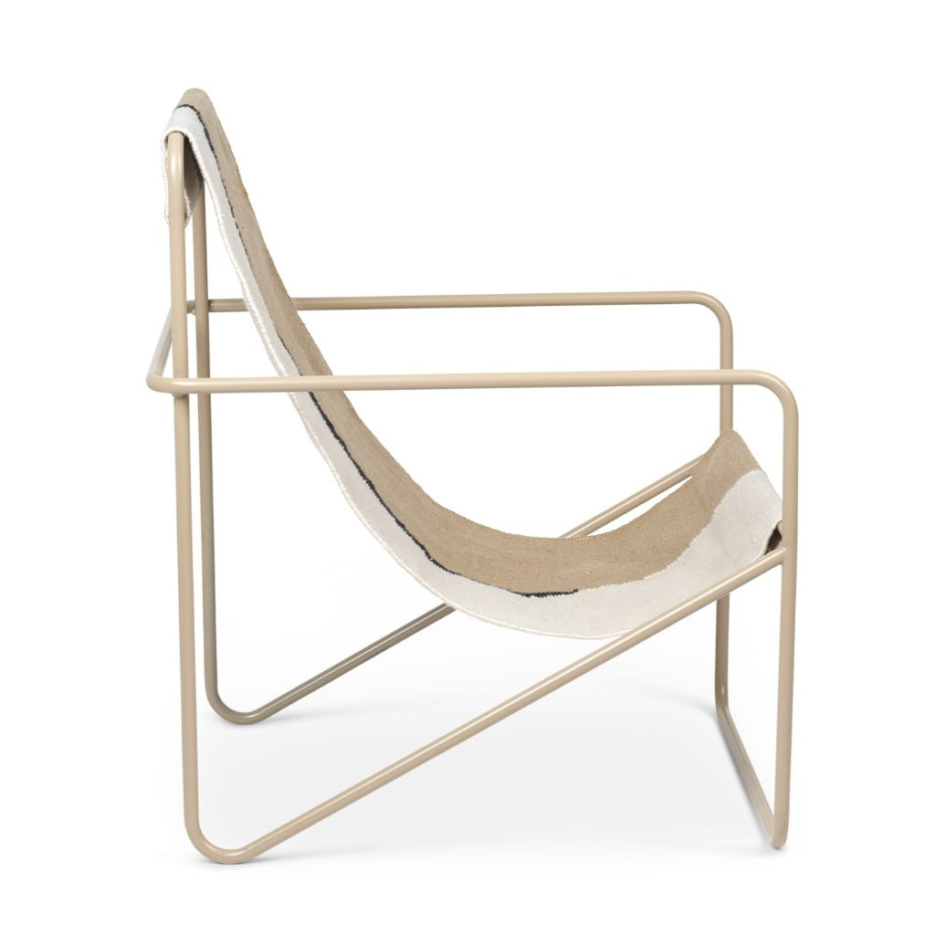 A Cashmere Soil Desert Lounge Chair by Ferm Living with a beige seat and a white back.