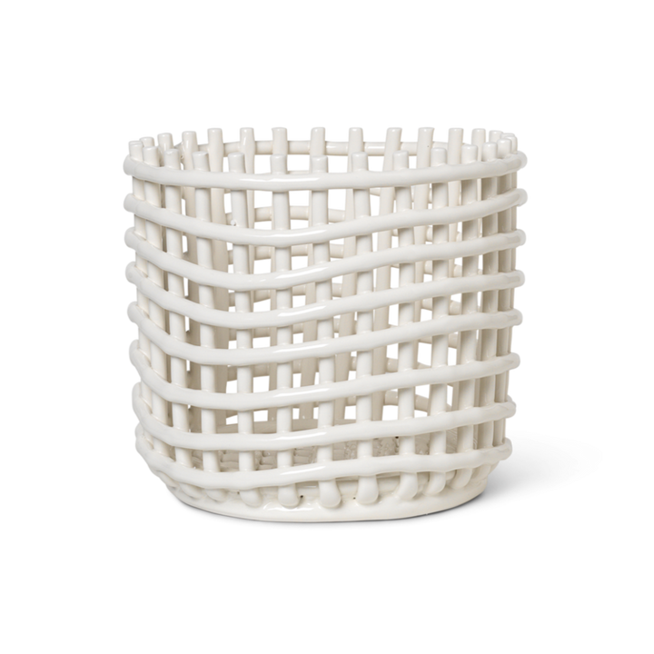 A white Ceramic Woven Basket vase with a lattice design on it by Ferm Living.