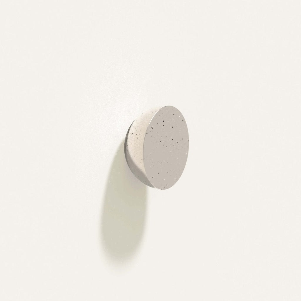 Cercle Knob in polished white bronze installed on a white wall.