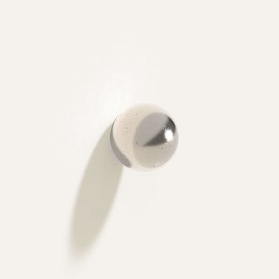 Cercle Knob Large in white bronze installed on a white wall.