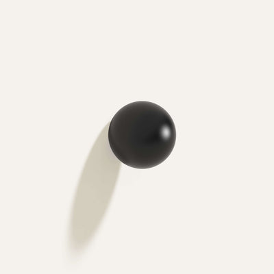 Cercle Knob Large in black installed on a white wall.