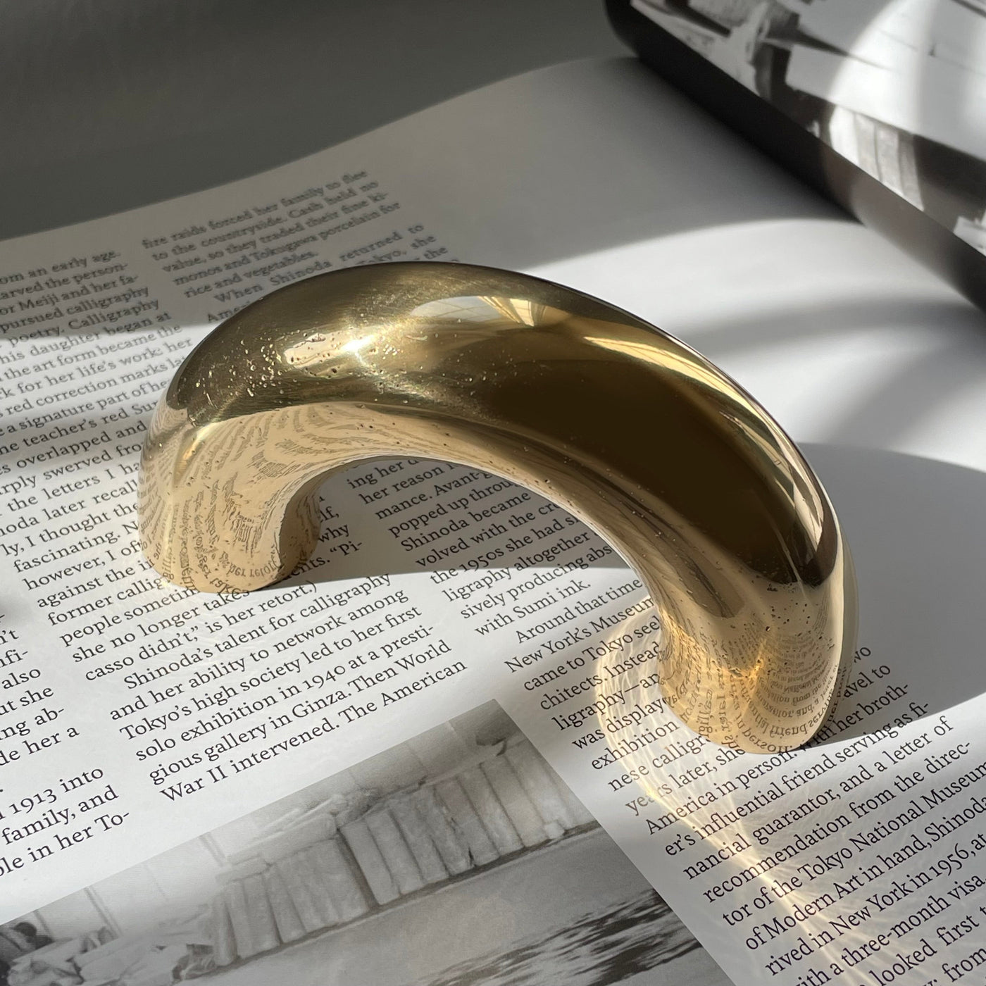 solid cast natural and white brass and bronze curved cabinet hardware handle by Maha Alavi