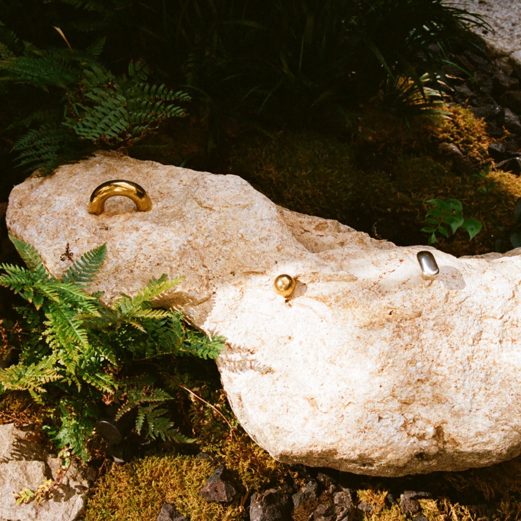 Maha Alavi Cercle thick pulls styled on a rock, two brass and one nickel.