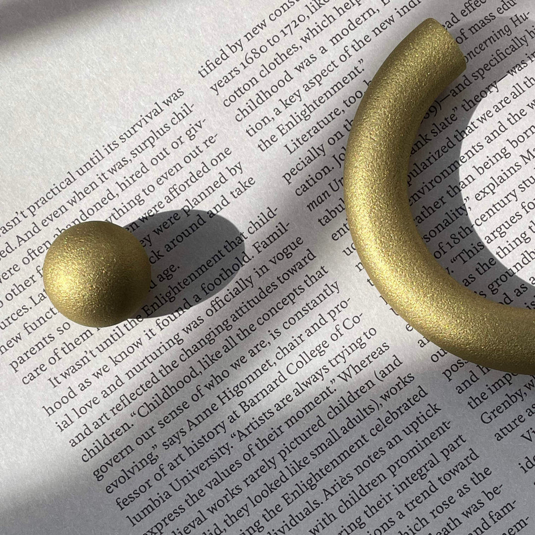 solid cast natural and white brass and bronze curved cabinet hardware handle by Maha Alavi