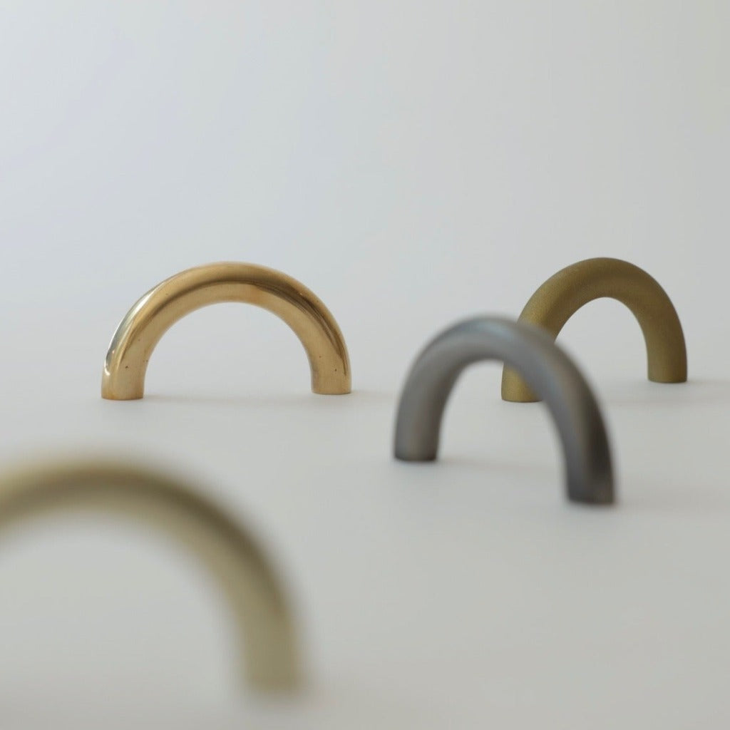 Brass and nickel Maha Alavi Cercle thin long pulls grouped.