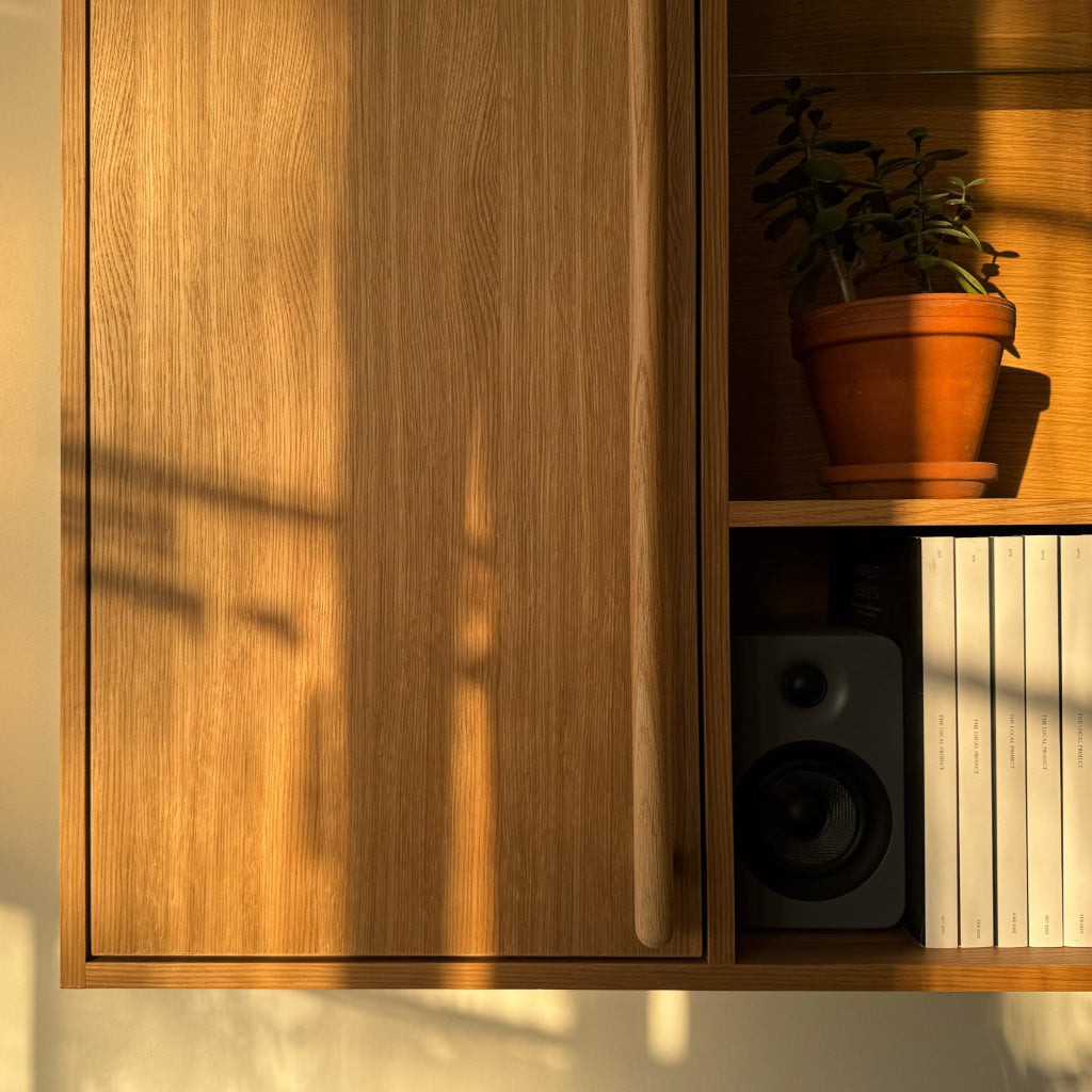 A wood-slat cabinet fitted with Chapman & Bose wood bar pulls.
