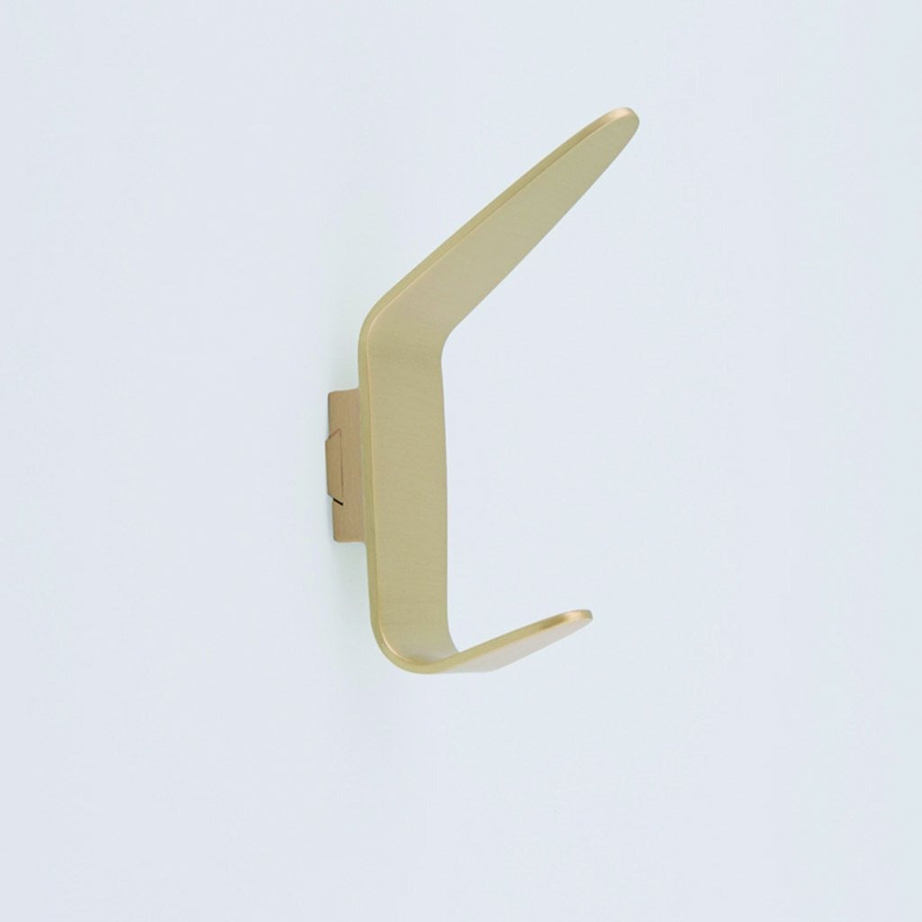 A close up of a CBH Charlie Angular Hook on a white wall.