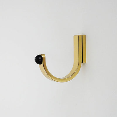 A close up of a CBH Charlie Bumper Hook on a wall.
