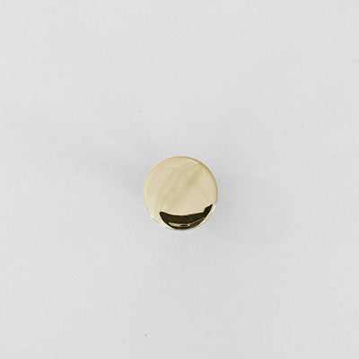 A small round Charlie Chunky Knob by CBH on a white surface.
