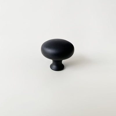 A CBH Charlie Finish Sample knob on a white surface.