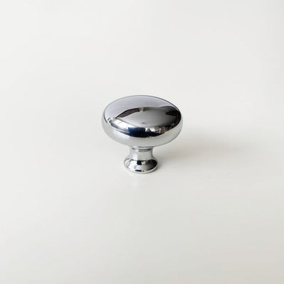 A shiny CBH Charlie Finish Sample knob on a white surface.