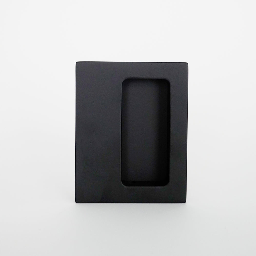 A CBH Charlie Flush Pull 340 Door and Cabinet with a black square object and a white background.