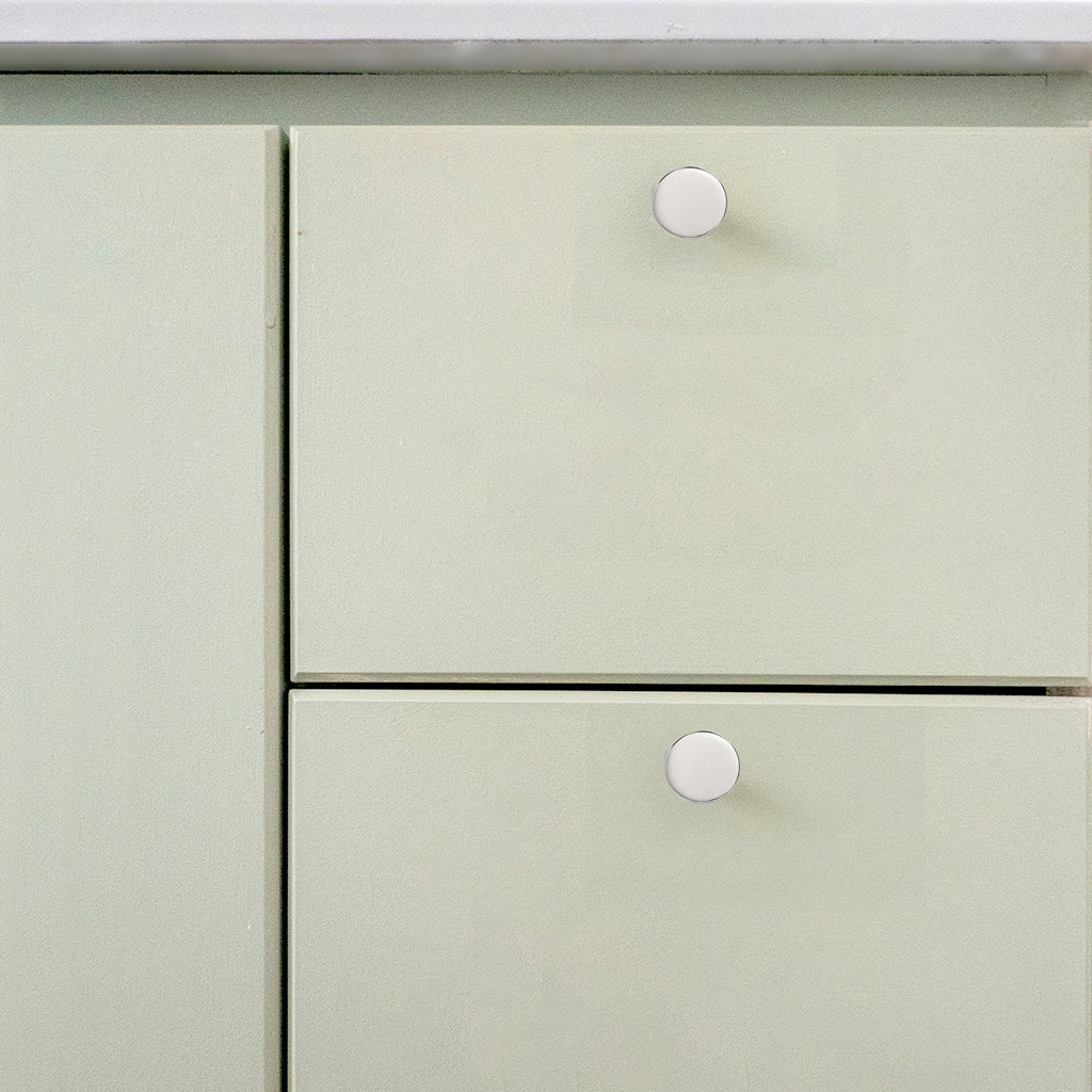 A close up of a white cabinet with two drawers featuring Charlie Moon Knobs from CBH.