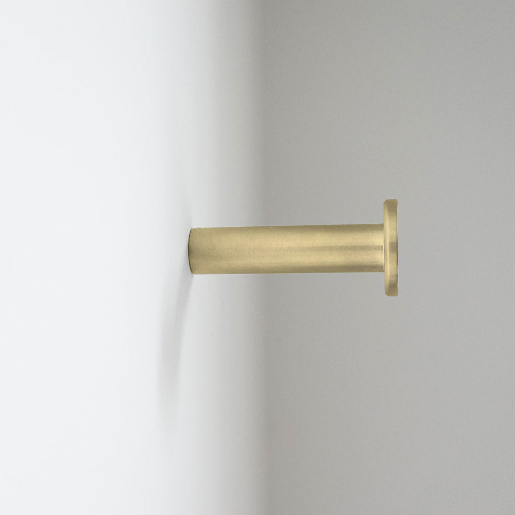 A close up of a CBH Charlie Nail Hook on a white wall.