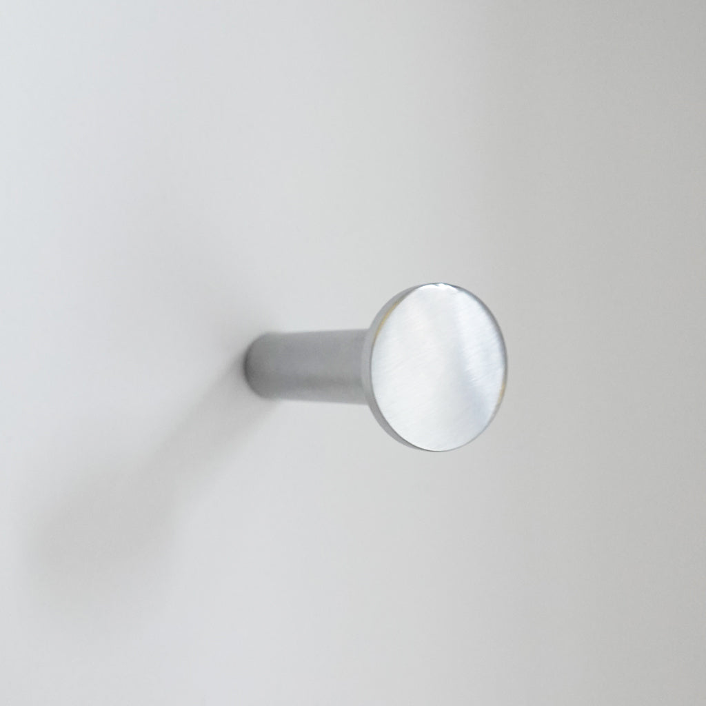 A close up of a CBH Charlie Nail Hook on a wall.