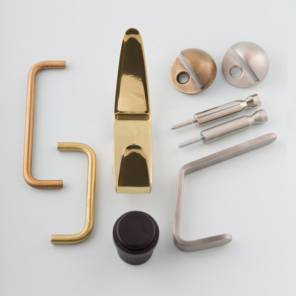 A variety of hardware and tools including CBH's Charlie Pencil Hook laid out on a white surface.