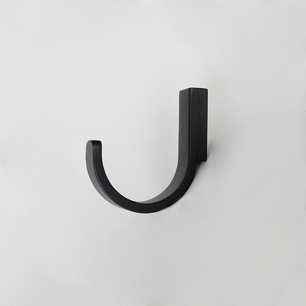 A CBH Charlie Round Hook on a white wall.
