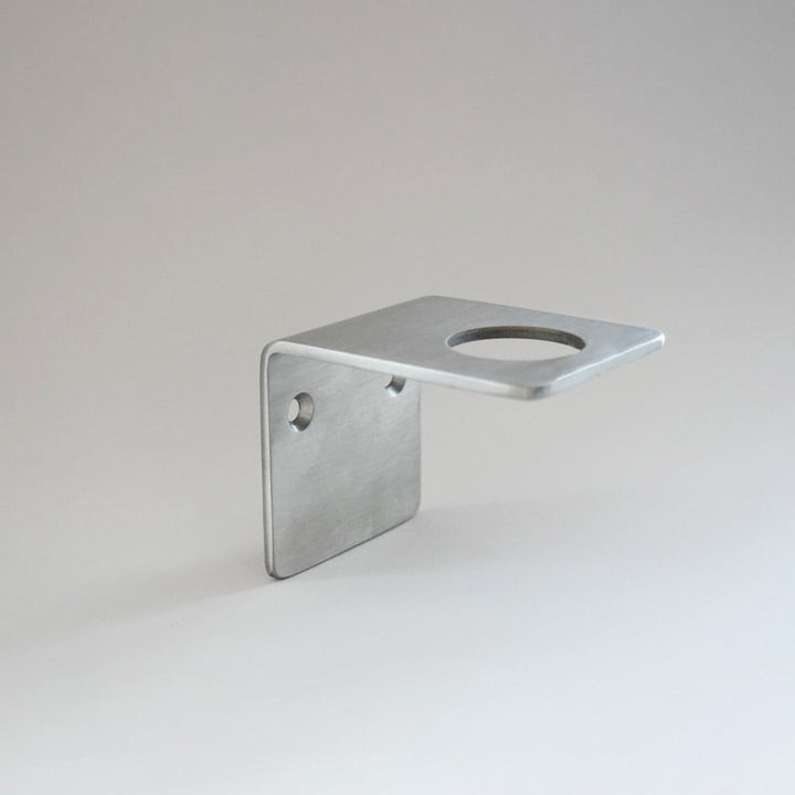 Satin stainless wall bracket of soap, cream and hand sanitizer.