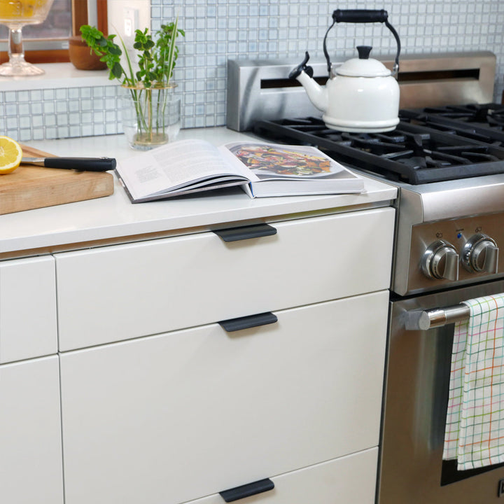 Matte black tab pull in modern kitchen. Hardware made in Toronto.