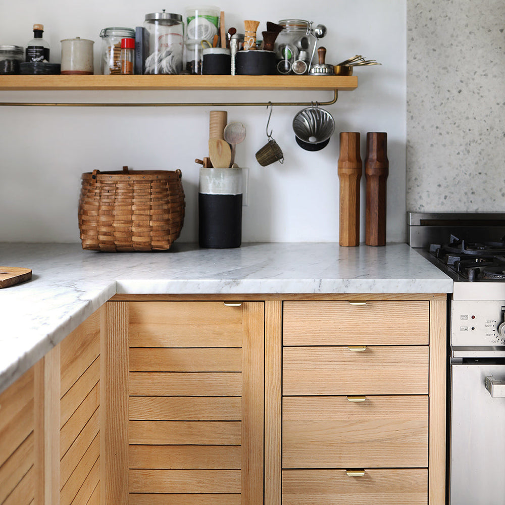 a kitchen with wooden cabinets and a CBH Charlie Tab Small counter top.