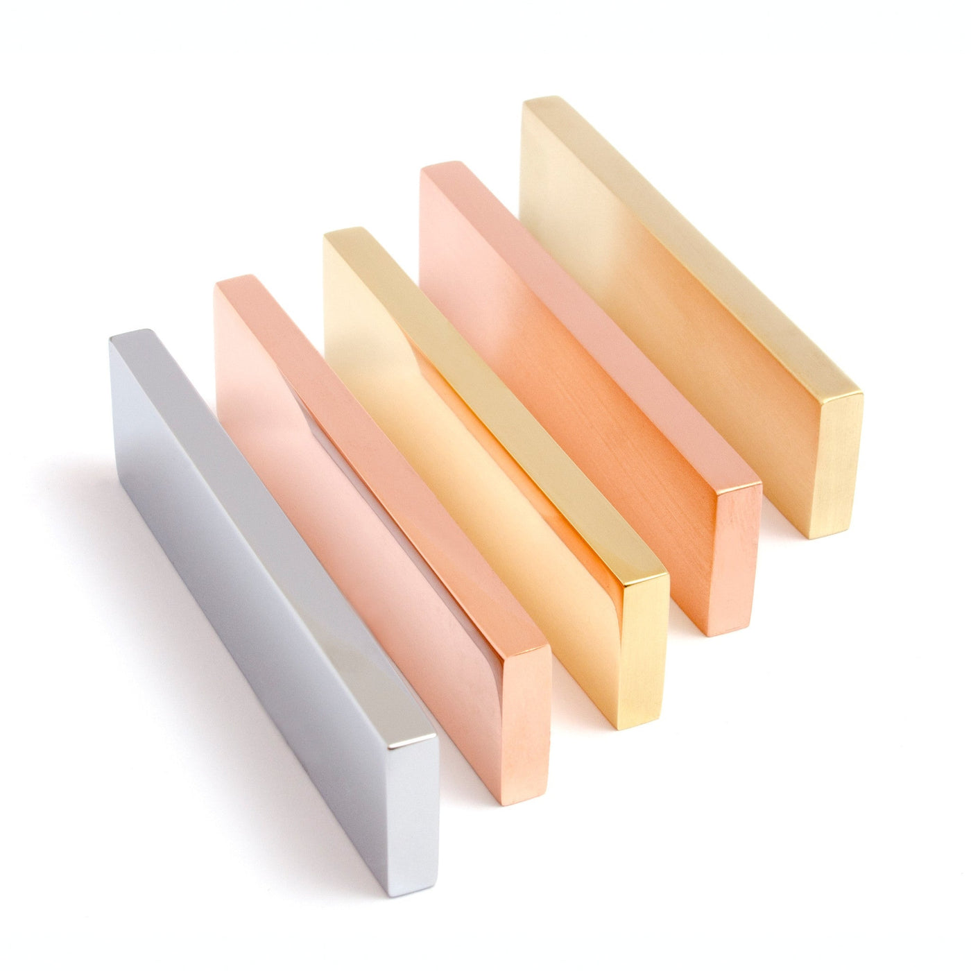 A group of three Baccman Berglund Clean Cut Pull wooden blocks, each a different color.