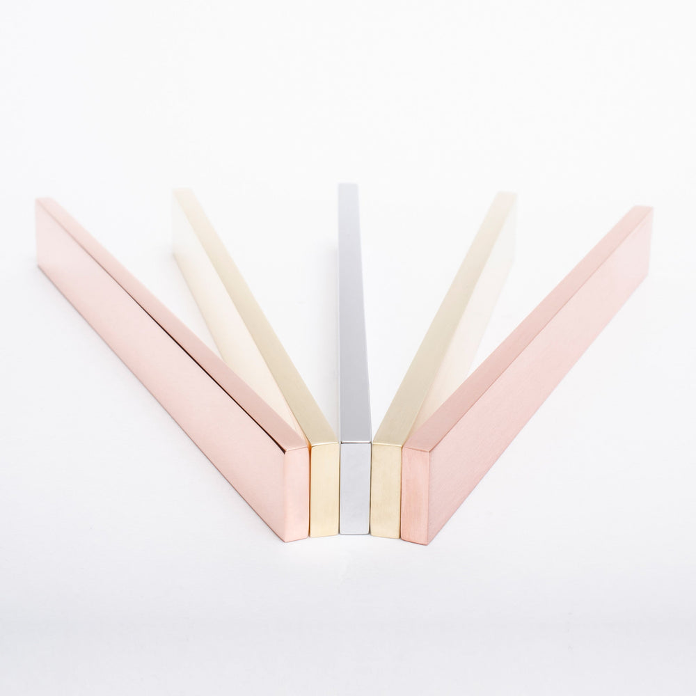 A pair of Baccman Berglund Clean Cut Pull scissors in pink and silver on a white surface.