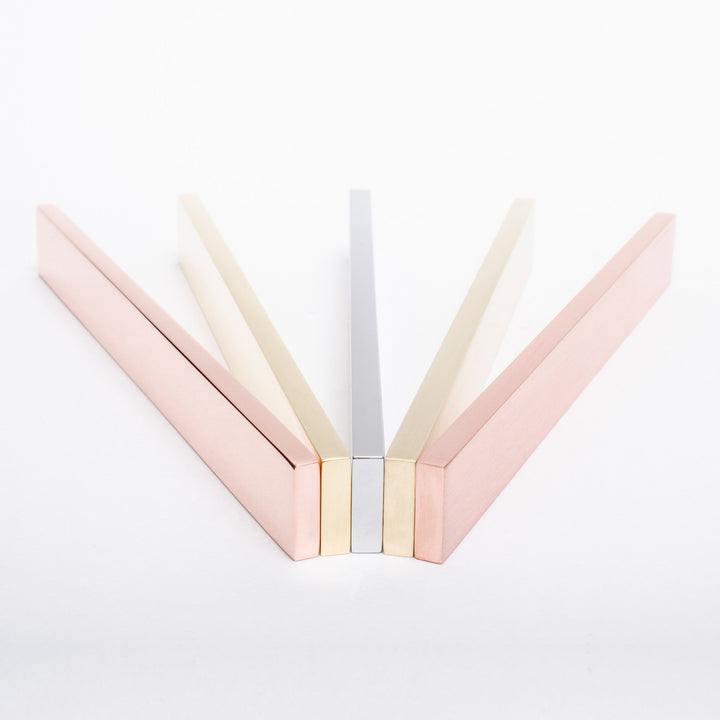 A pair of Baccman Berglund Clean Cut Pull scissors in pink and silver on a white surface.