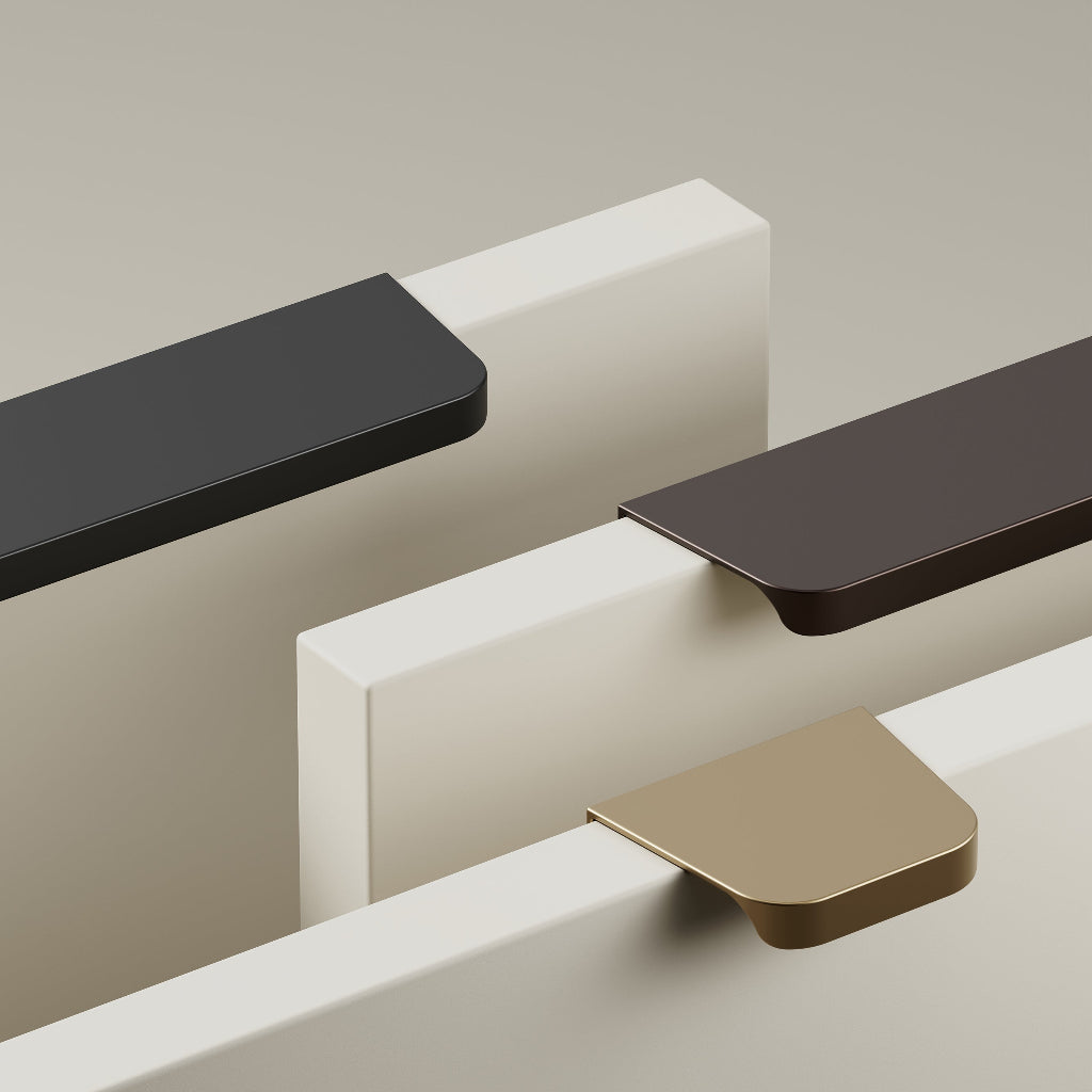 Furnipart Comet edge pulls in matte black, matte bronze, and matte brass mounted on painted sample boards.