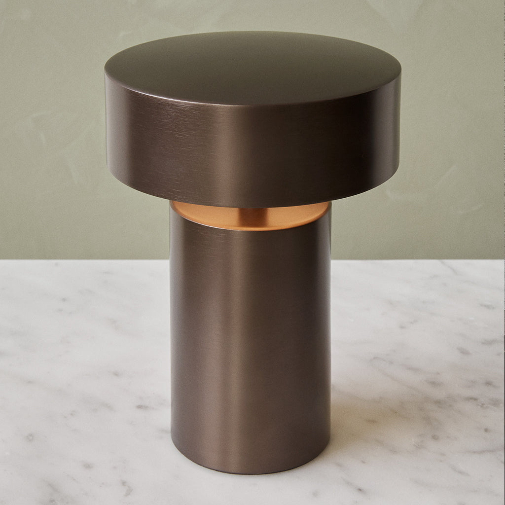 A close up of an Audo Column LED Table Lamp on a table.