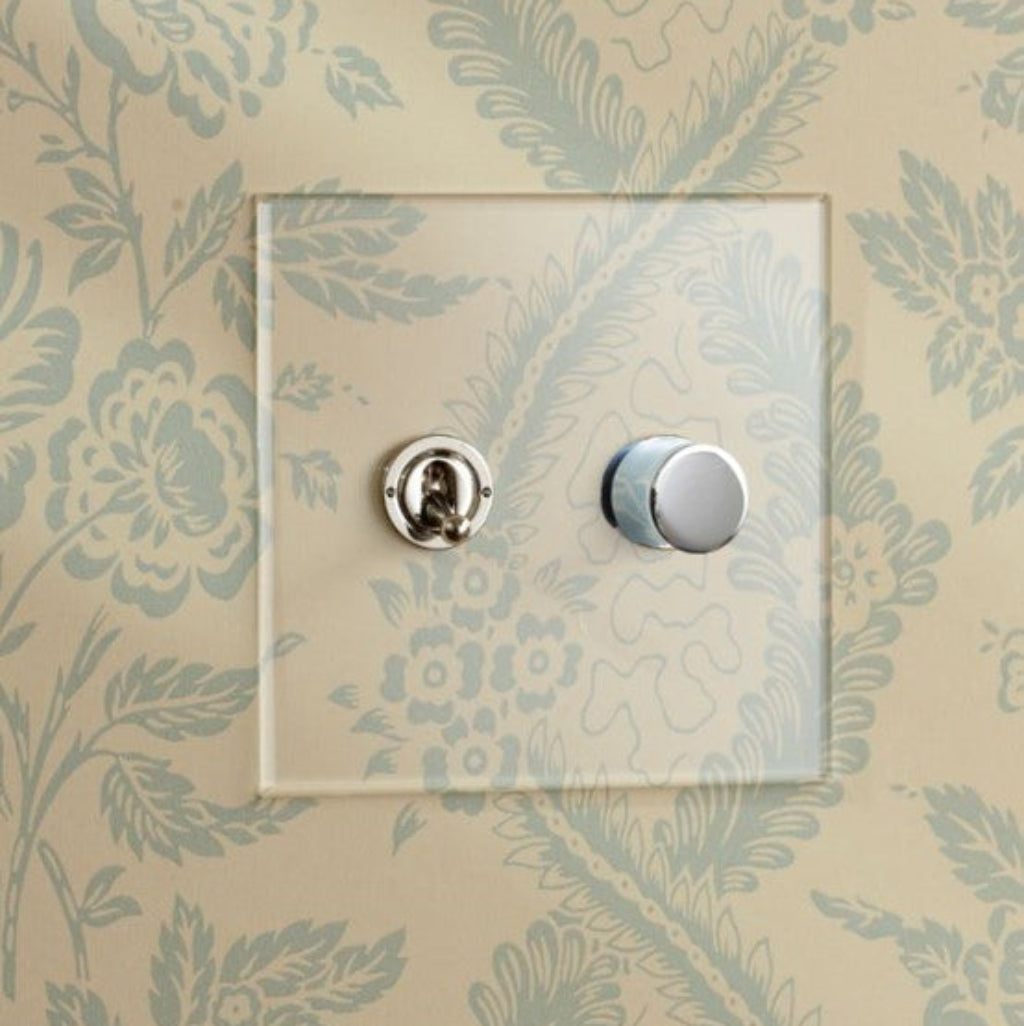 Forbes & Lomax invisible plate with a toggle and nickel dimmer on floral wallpaper.