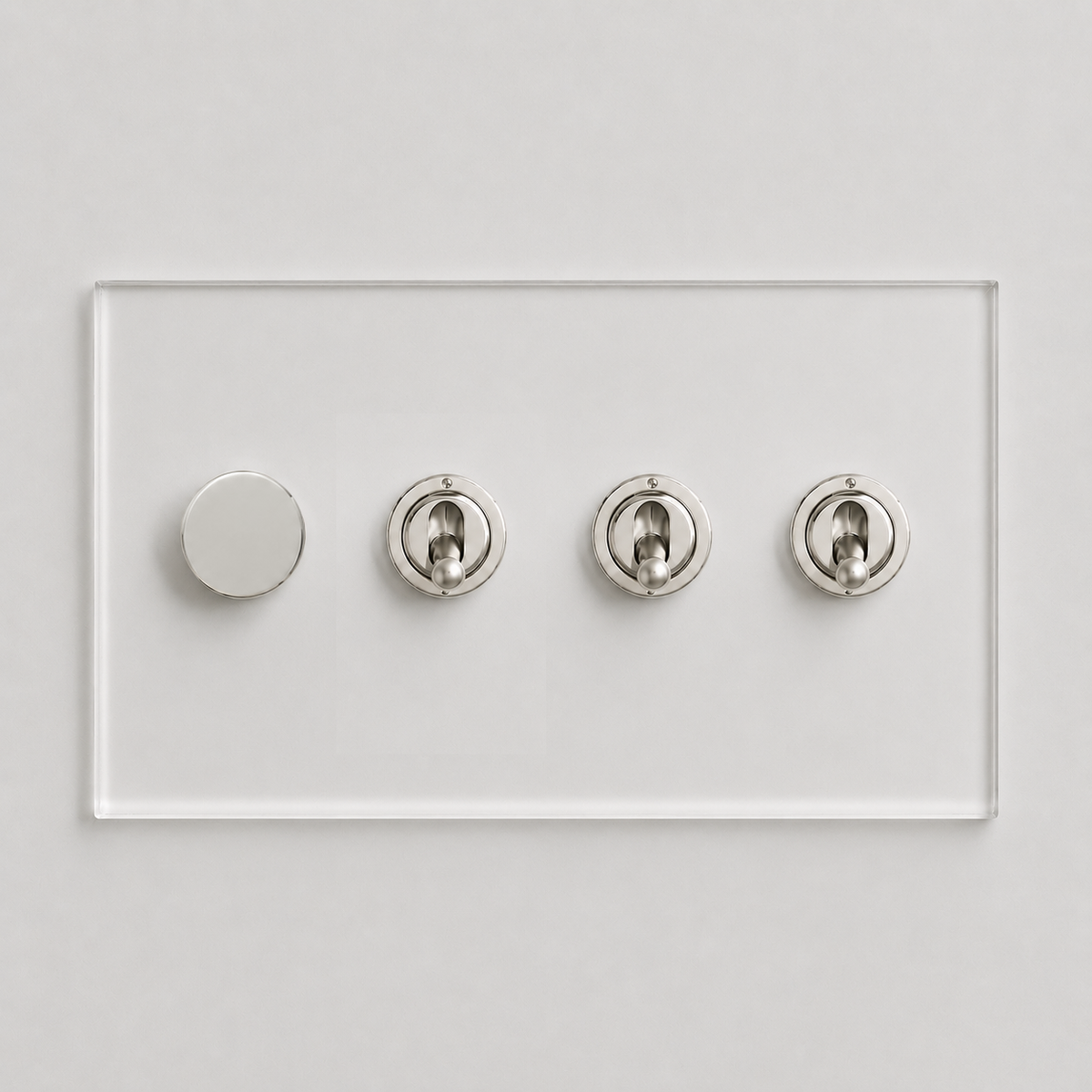 Forbes & Lomax Invisible plate with one nickel rotary dimmer and three nickel toggle switches on clear acrylic.
