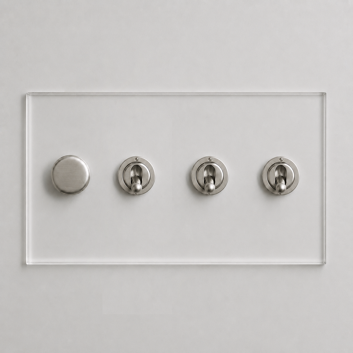 Forbes & Lomax invisible acrylic plate with one brushed nickel rotary dimmer and three matching toggle light switches.
