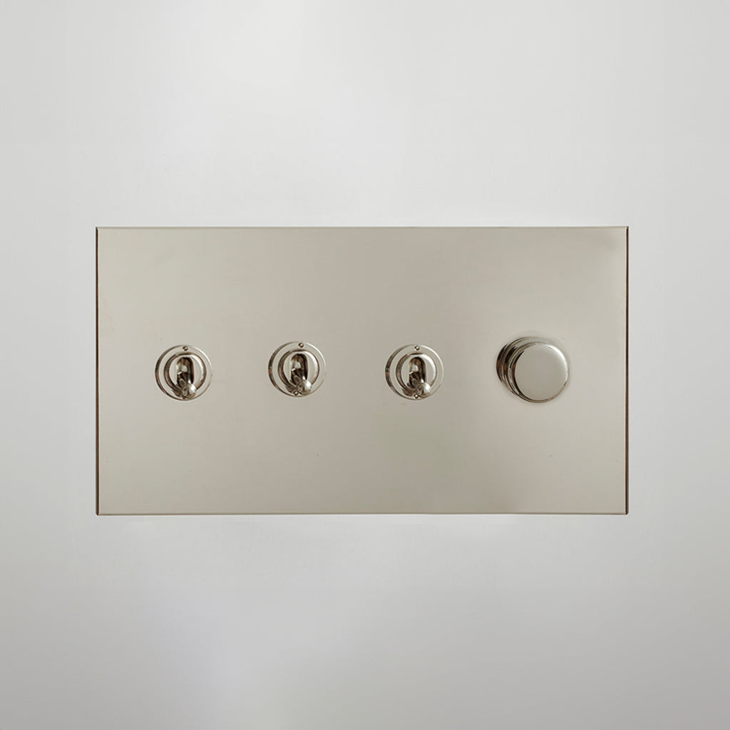 Nickel Forbes & Lomax switch plate with three toggles and a dimmer.