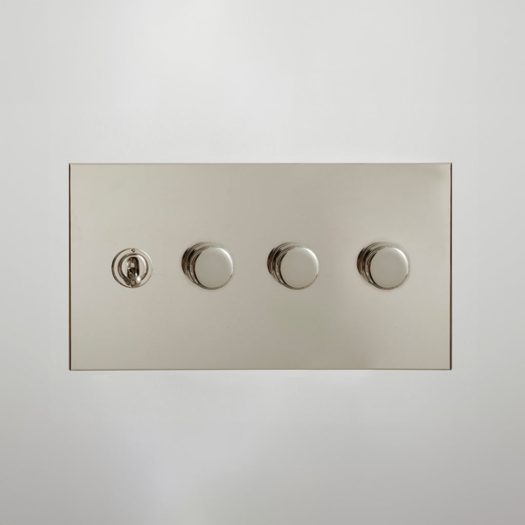 Nickel Forbes & Lomax switch plate with a toggle and three dimmers.