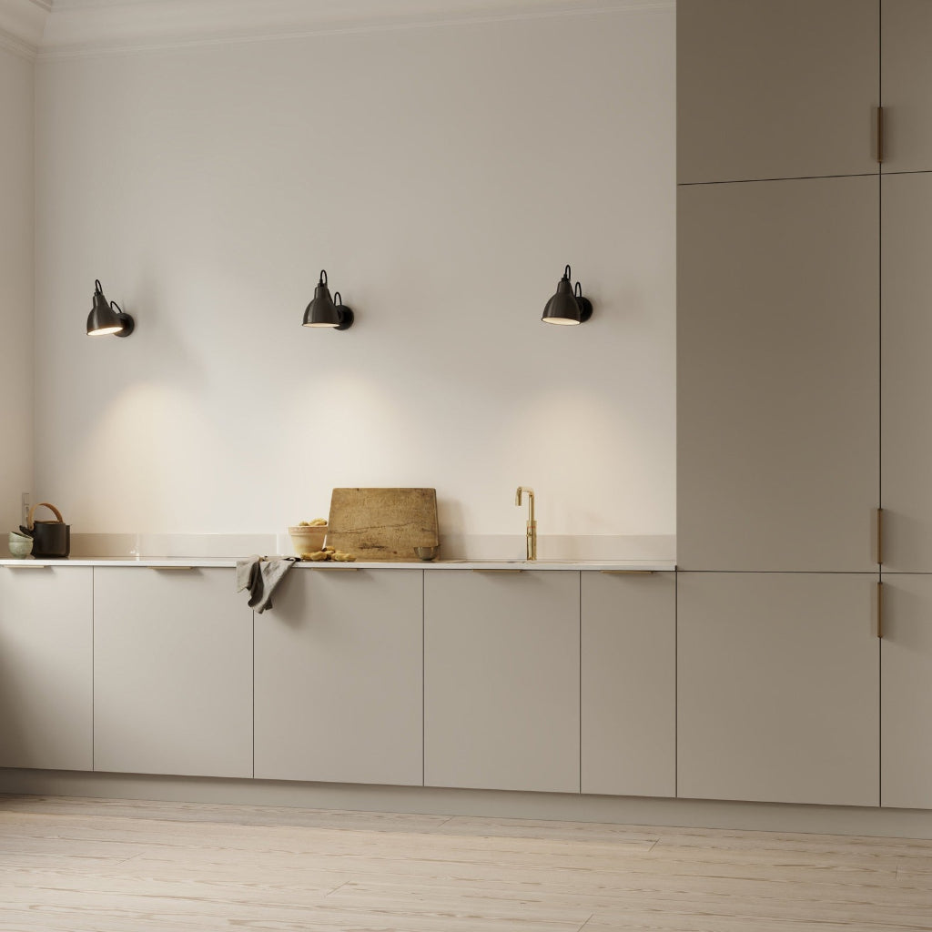 Beige kitchen with matte brass Furnipart Comet edge pulls on the base and tall cabinet doors.