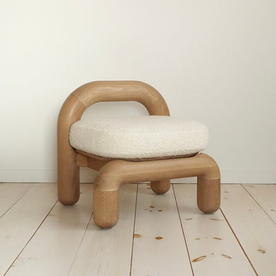lithic lounge chair in natural oak with cream upholstery seat