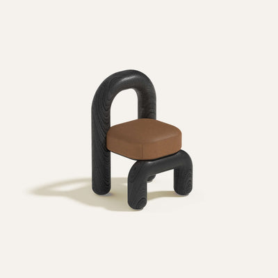 lithic chair with black oak frame and cognac leather seat