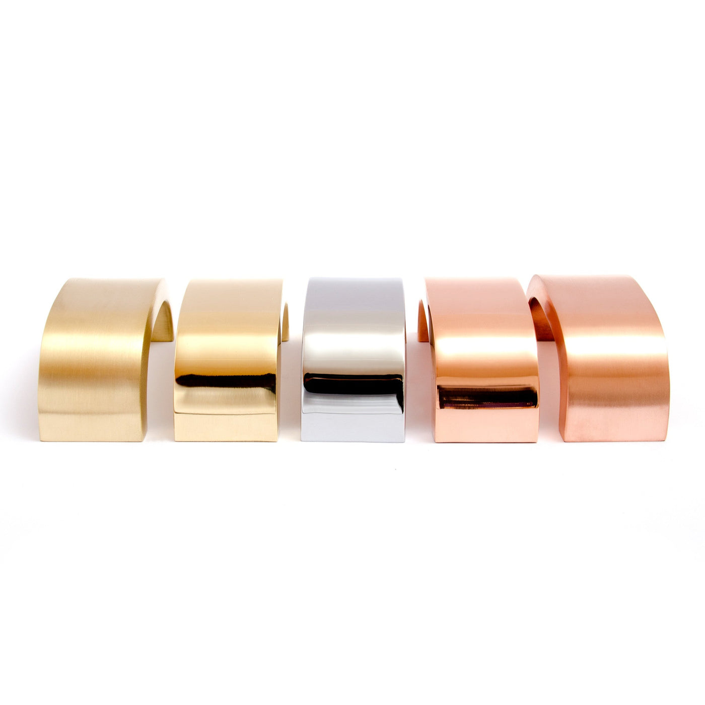 A row of Baccman Berglund Curve Handle rings in different colors on a white background.