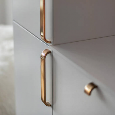 Brass curve handle and knob on modern cabinets.