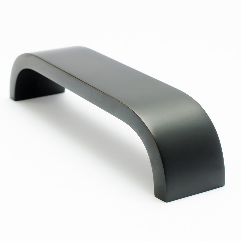 A close up of a Baccman Berglund Curve Handle on a white background.